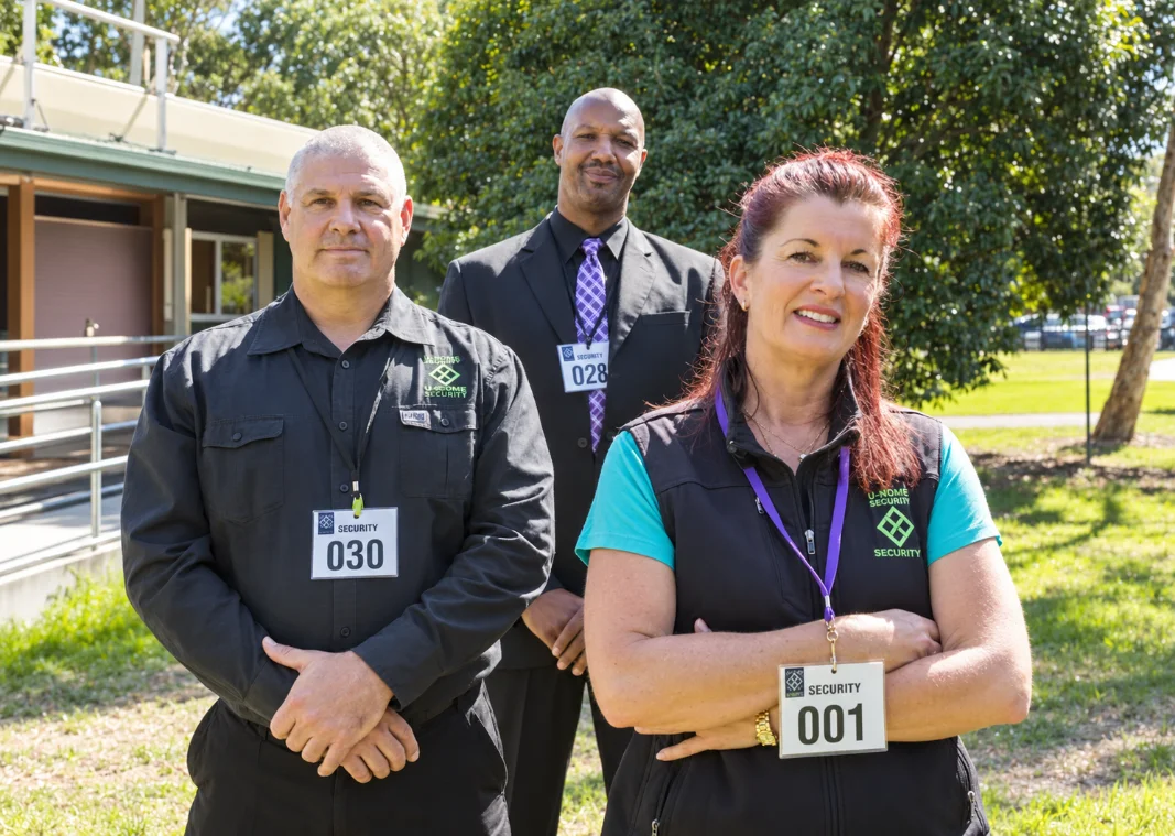 Naomi Oakley with two U-Nome Security officers at a daytime event